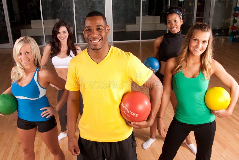 A fitness instructor leads a group of women. A fitness instructor leads a group of women