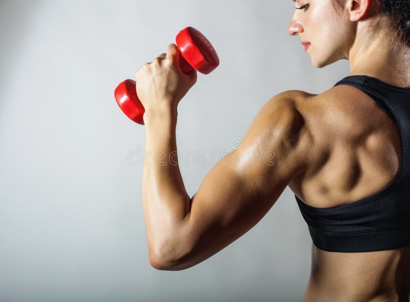 Fitness woman with barbells on grey background. Fitness woman with barbells on grey background