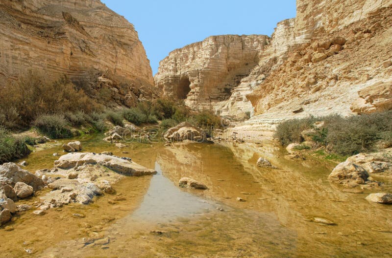 Horizontal oriented image of small pond among mountains at Ein Avdat Canyon in Negev desert, Israel. Horizontal oriented image of small pond among mountains at Ein Avdat Canyon in Negev desert, Israel.