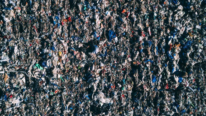 A landfill site full of trash plastic in the desert orange soil territory, aerial view. A landfill site full of trash plastic in the desert orange soil territory, aerial view