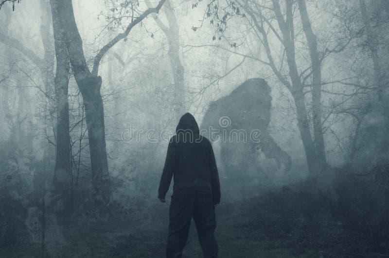 A dark scary concept. Of a man watching a mysterious bigfoot figure, walking through a forest. Silhouetted against trees. On a foggy winters day. With a grunge, textured edit. A dark scary concept. Of a man watching a mysterious bigfoot figure, walking through a forest. Silhouetted against trees. On a foggy winters day. With a grunge, textured edit.