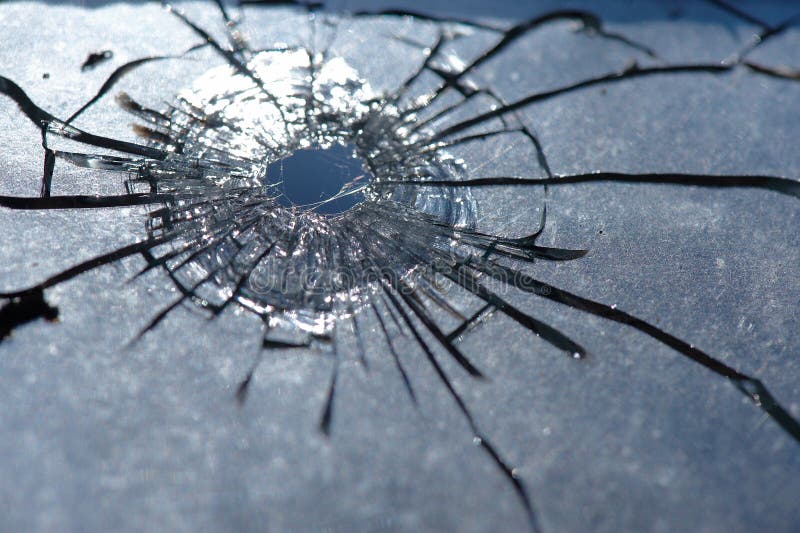 Photo broken window looks like a bullet hole. Photo broken window looks like a bullet hole
