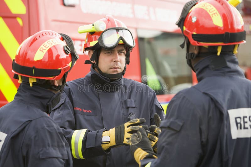 A firefighter giving instructions to his team. A firefighter giving instructions to his team.