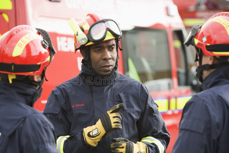 A firefighter giving instructions to his team. A firefighter giving instructions to his team.
