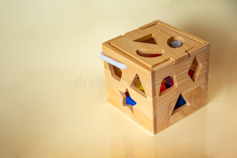 Ein hölzernes handgemachtes Spielzeug für Kinder auf gelbem Hintergrund. ökologisches Konzept stockfotografie
