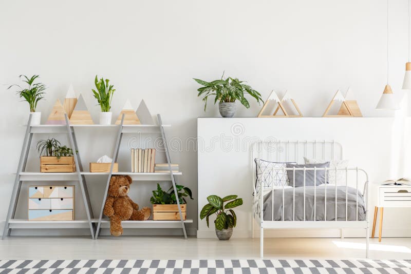 A classic child bedroom interior with simple, scandinavian style furniture and a gray wooden bookcase with a teddy bear concept. A classic child bedroom interior with simple, scandinavian style furniture and a gray wooden bookcase with a teddy bear concept