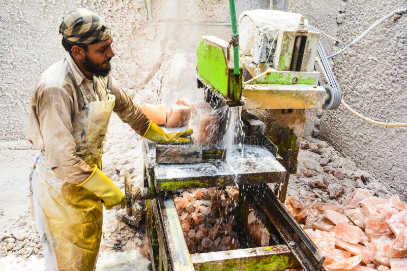 A man cutting rock salt to make tiles & bricks. Natural lamps are famous all over the world for their unique beautiful light. These salt lamps emit colorful apricot, yellow & orange light. These are carefully crafted from rock salt taken from mines in Salt Range Mountain located near Quaidabad, Khushab, Pakistan. Natural salt lamps are used to decorate drawing rooms, offices & bedrooms. It ionizes and purifies the air which can be very healthful for asthma & patients with joint pains. Today, the health benefits of ionizers are well recognized; whilst most ionizers in the market are manmade, the crystal salt lamps are Mother Nature`s beautiful alternative. A man cutting rock salt to make tiles & bricks. Natural lamps are famous all over the world for their unique beautiful light. These salt lamps emit colorful apricot, yellow & orange light. These are carefully crafted from rock salt taken from mines in Salt Range Mountain located near Quaidabad, Khushab, Pakistan. Natural salt lamps are used to decorate drawing rooms, offices & bedrooms. It ionizes and purifies the air which can be very healthful for asthma & patients with joint pains. Today, the health benefits of ionizers are well recognized; whilst most ionizers in the market are manmade, the crystal salt lamps are Mother Nature`s beautiful alternative.