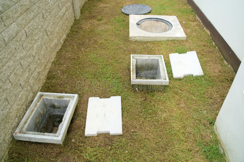 A man hole water and a hole of grease trap with the drain system around the house and home. A man hole water and a hole of grease trap with the drain system around the house and home.