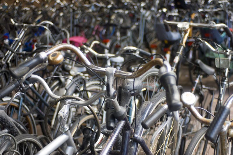 Bicycles parked at the railway station; focus on the aluminum bike in the lower left This image is part of the collection. Bicycles parked at the railway station; focus on the aluminum bike in the lower left This image is part of the collection