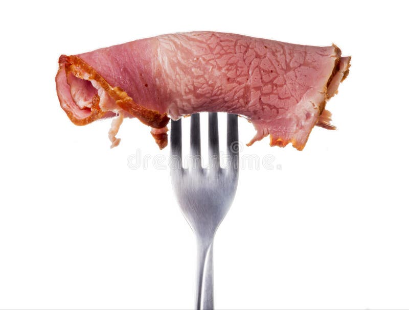 A piece of meat on a fork on a white background. A piece of meat on a fork on a white background