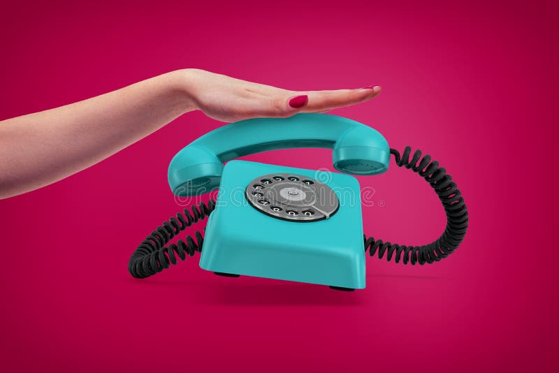 An elegant female hand presses down a handle of a retro blue rotary phone that rings and almost jumps up. Getting important call. Call service. Classic communication. An elegant female hand presses down a handle of a retro blue rotary phone that rings and almost jumps up. Getting important call. Call service. Classic communication.