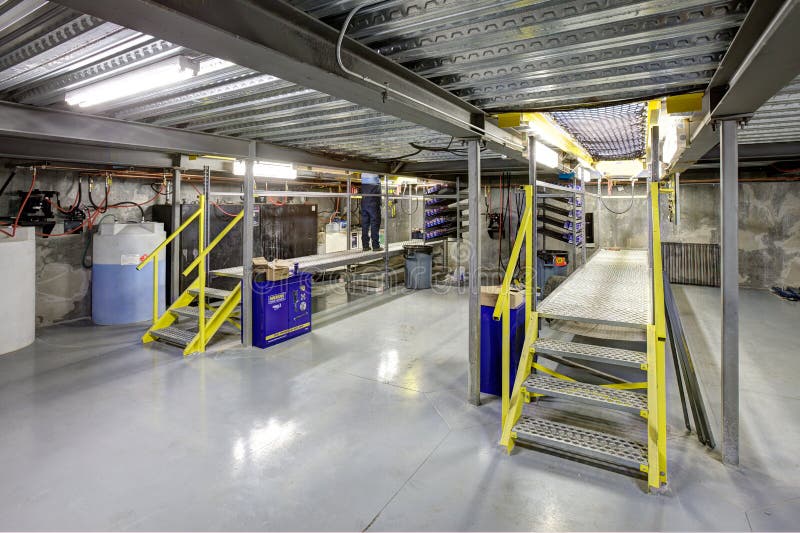 The grease pit in a modern automotive repair facility.  This image is taken from below the ground level where the mechanics work under the cars. The grease pit in a modern automotive repair facility.  This image is taken from below the ground level where the mechanics work under the cars