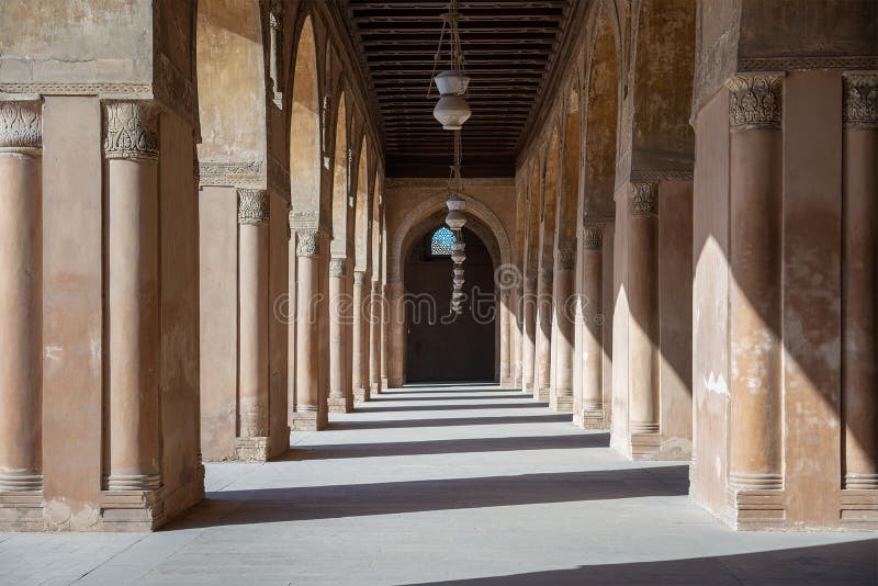 One of the passages surrounding the courtyard of the Mosque of Ahmad Ibn Tulun framed by huge decorated arches, old Cairo, Egypt. One of the passages surrounding the courtyard of the Mosque of Ahmad Ibn Tulun framed by huge decorated arches, old Cairo, Egypt