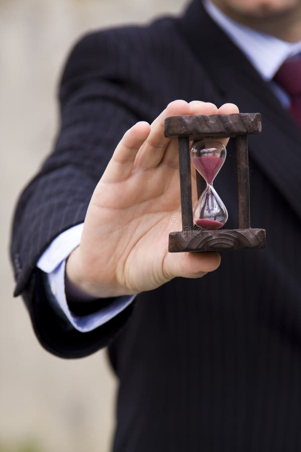 A businessman showing how to save time (selective and soft focus). A businessman showing how to save time (selective and soft focus)