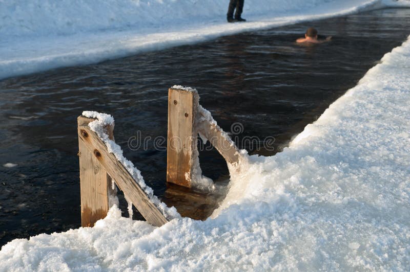 Ice hole winter swimming. Air temperature -13 C (10 F). Ice hole winter swimming. Air temperature -13 C (10 F).