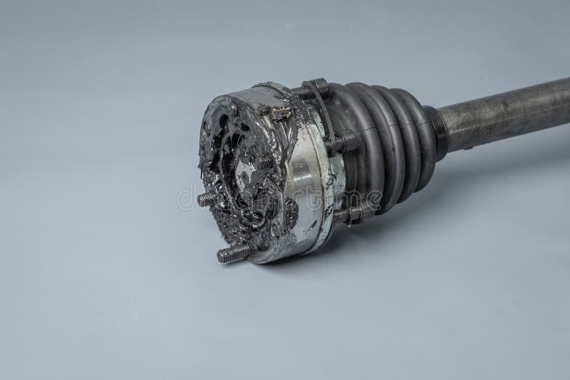 Axle half shaft, used, exposed and greased. Removed from vehicle with some dirt visible. Half axle or constant velocity joint with a lot of grease. Axle half shaft, used, exposed and greased. Removed from vehicle with some dirt visible. Half axle or constant velocity joint with a lot of grease