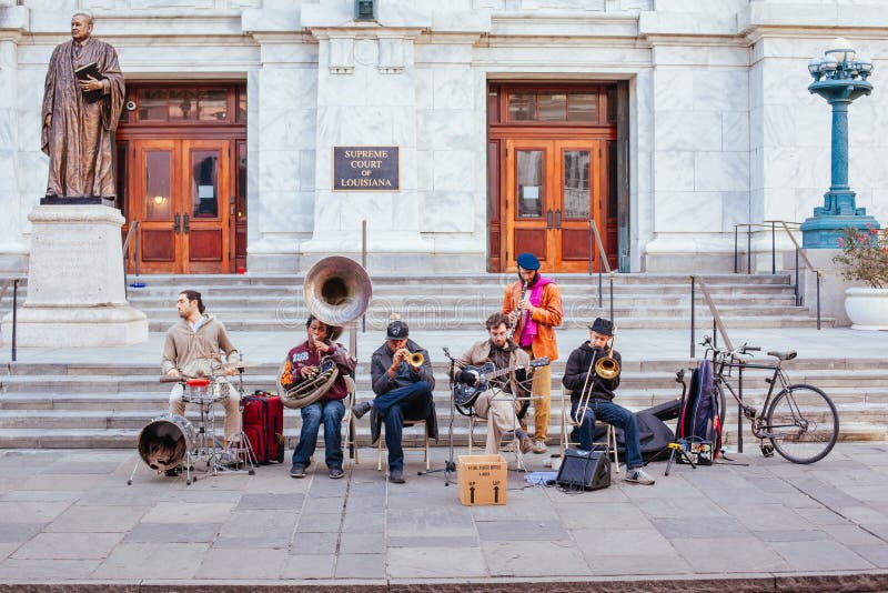 New Orleans, USA - Jan 19 2013: Local jazz band performs in the streets for money in New Orleans, USA. New Orleans, USA - Jan 19 2013: Local jazz band performs in the streets for money in New Orleans, USA