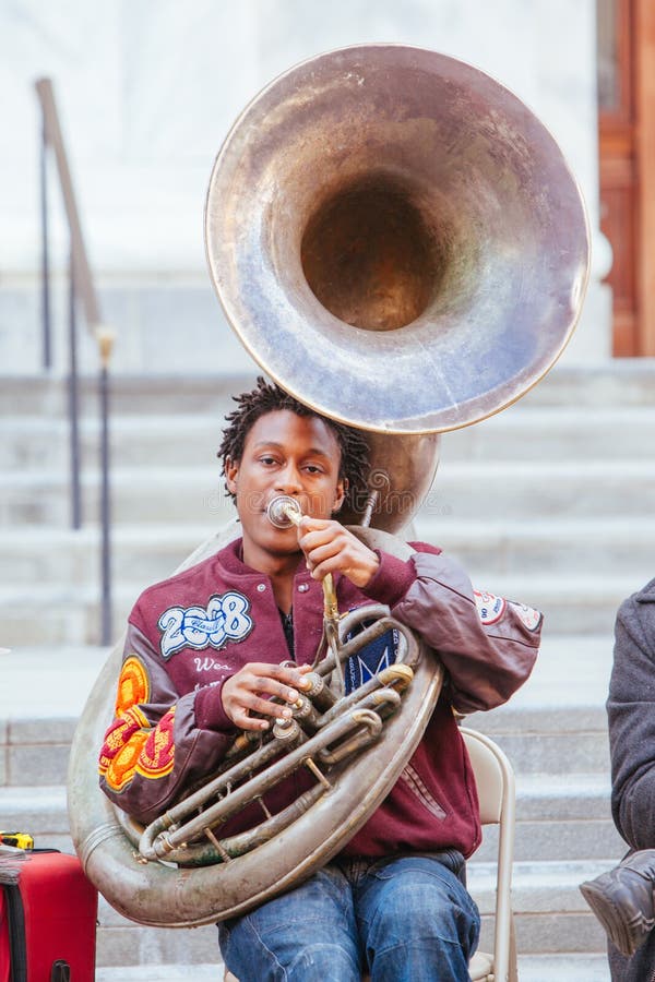 New Orleans, USA - Jan 19 2013: Local jazz band performs in the streets for money in New Orleans, USA. New Orleans, USA - Jan 19 2013: Local jazz band performs in the streets for money in New Orleans, USA