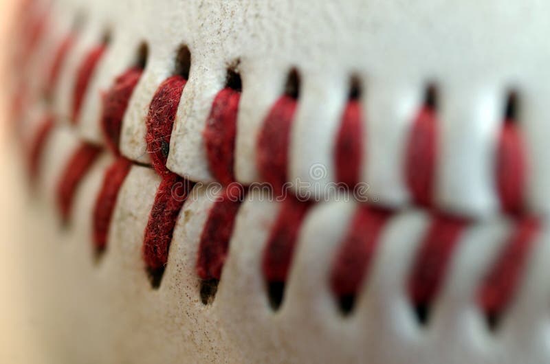 Close up of the blood red seams of a regulation baseball. Close up of the blood red seams of a regulation baseball