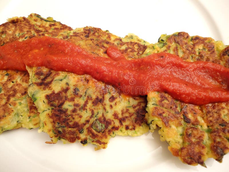 Photo of italian food-zucchini cakes made with zucchini, cheese, flower, eggs and other spices. These patties were fried and can be served as an appetizer topped with marinara sauce. Photo of italian food-zucchini cakes made with zucchini, cheese, flower, eggs and other spices. These patties were fried and can be served as an appetizer topped with marinara sauce.