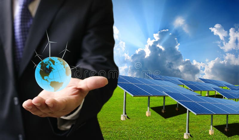 El concepto verde de la energía, hombre de negocios lleva el mundo de la turbina de viento foto de archivo libre de regalías El concepto verde de la energía, hombre de negocios lleva el mundo de la turbina de viento foto de archivo libre de regalías