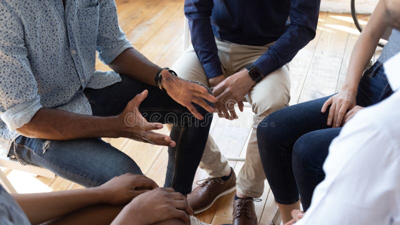 El consejero africano del hombre habla en el grupo que aconseja la sesión de terapia El consejero africano del hombre habla en el grupo que aconseja la sesión de terapia