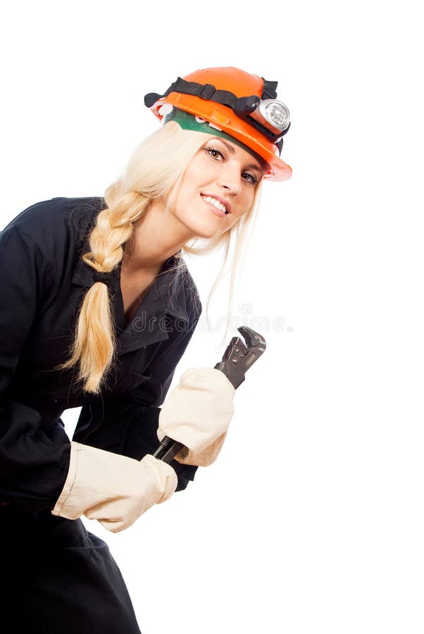 El constructor de la muchacha en un casco mira imagenes de archivo El constructor de la muchacha en un casco mira imagenes de archivo