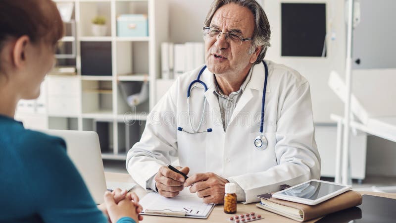 El doctor y el paciente están discutiendo en la clínica imágenes de archivo libres de regalías El doctor y el paciente están discutiendo en la clínica imágenes de archivo libres de regalías