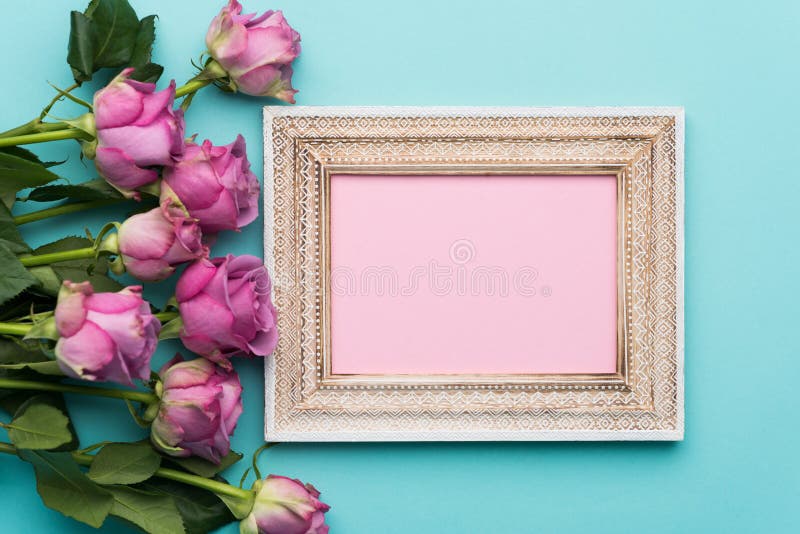 Happy Mother`s Day, Women`s Day, Valentine`s Day or Birthday Flat Lay Background. Beautiful wooden vintage picture frame, fresh pink roses and copy space. Happy Mother`s Day, Women`s Day, Valentine`s Day or Birthday Flat Lay Background. Beautiful wooden vintage picture frame, fresh pink roses and copy space.