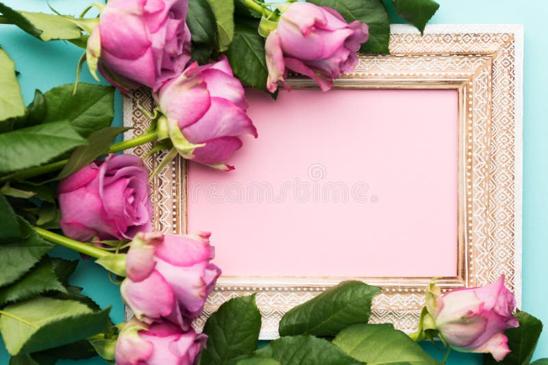 Happy Mother`s Day, Women`s Day, Valentine`s Day or Birthday Flat Lay Background. Beautiful wooden vintage picture frame, fresh pink roses and copy space. Happy Mother`s Day, Women`s Day, Valentine`s Day or Birthday Flat Lay Background. Beautiful wooden vintage picture frame, fresh pink roses and copy space.