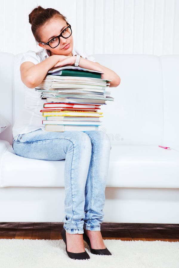 University student with books sit on sofa. University student with books sit on sofa