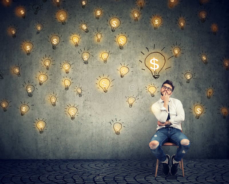 Portrait thinking handsome young man sitting on chair looking up at many dollar idea light bulbs above head. Portrait thinking handsome young man sitting on chair looking up at many dollar idea light bulbs above head