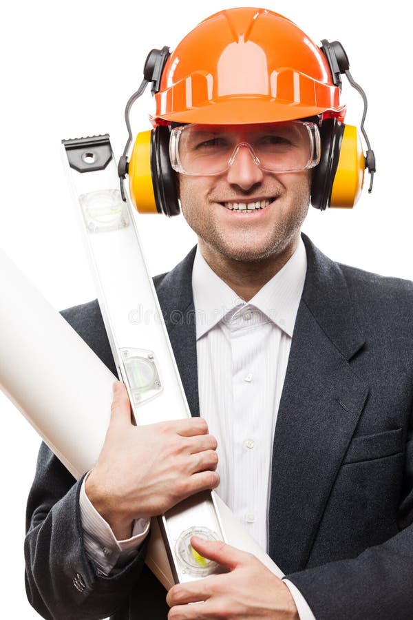 El hombre de negocios en el casco del casco de protección de la seguridad que sostiene los dibujos de papel planea fotografía de archivo El hombre de negocios en el casco del casco de protección de la seguridad que sostiene los dibujos de papel planea fotografía de archivo