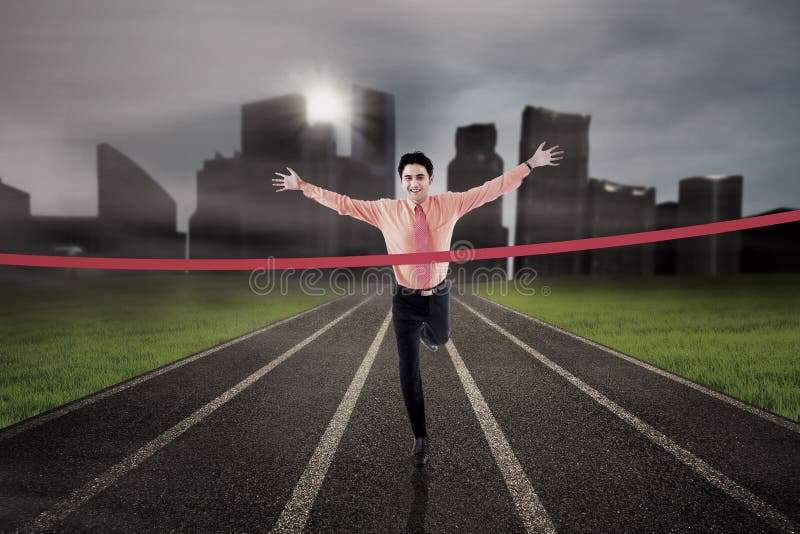 Businessman is finishing the race on city background. Businessman is finishing the race on city background