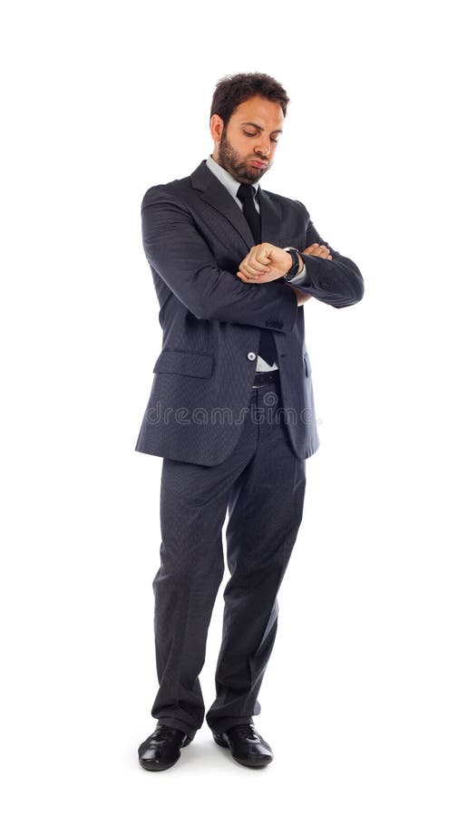 El hombre de negocios joven mira el reloj imagen de archivo El hombre de negocios joven mira el reloj imagen de archivo