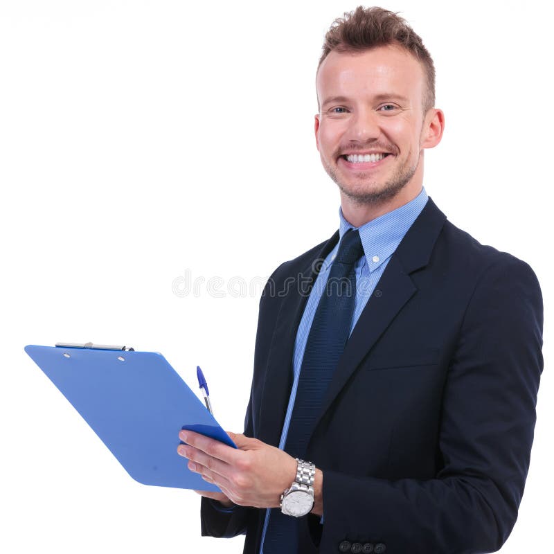 El hombre de negocios sonríe con la pluma y el tablero fotografía de archivo El hombre de negocios sonríe con la pluma y el tablero fotografía de archivo