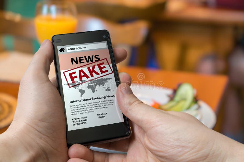 Man is holding smartphone and reading fake news on internet. Propaganda, disinformation and hoax concept. Man is holding smartphone and reading fake news on internet. Propaganda, disinformation and hoax concept.