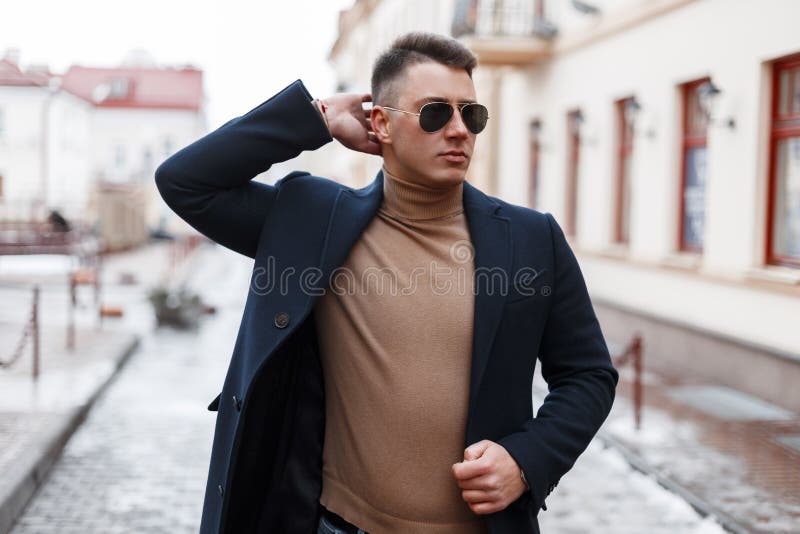 El Hombre Joven Acertado Hermoso Del Inconformista En Una Capa Elegante Del  Vintage En Lentes De Sol Negros En Un Suéter Hecho Pu Imagen de archivo -  Imagen de modelo, fashionable: 139127583