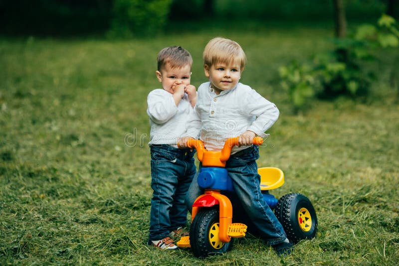 El juego de niños y monta una bicicleta fotografía de archivo libre de regalías El juego de niños y monta una bicicleta fotografía de archivo libre de regalías