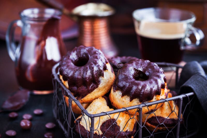 El mini bundt de mármol se apelmaza con helar del chocolate fotos de archivo libres de regalías El mini bundt de mármol se apelmaza con helar del chocolate fotos de archivo libres de regalías