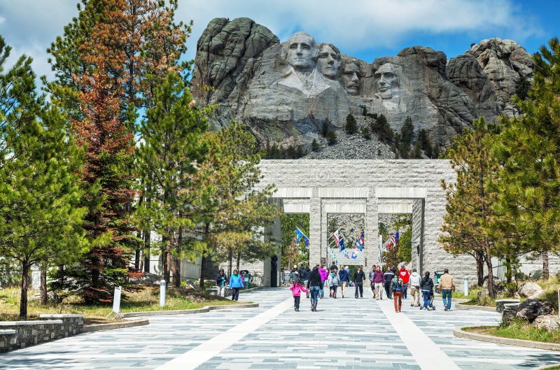 KEYSTONE, SD - MAY 10: Mount Rushmore monument with tourists on May 10, 2014 near Keystone, SD. It's a sculpture carved into the granite features 60-foot sculptures of the heads of 4 US presidents. KEYSTONE, SD - MAY 10: Mount Rushmore monument with tourists on May 10, 2014 near Keystone, SD. It's a sculpture carved into the granite features 60-foot sculptures of the heads of 4 US presidents.