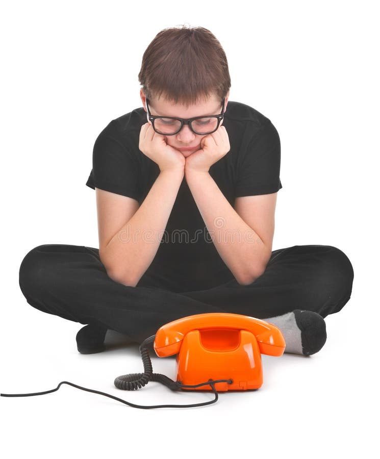 Sad boy is waiting for expected phonecall over white background. Sad boy is waiting for expected phonecall over white background