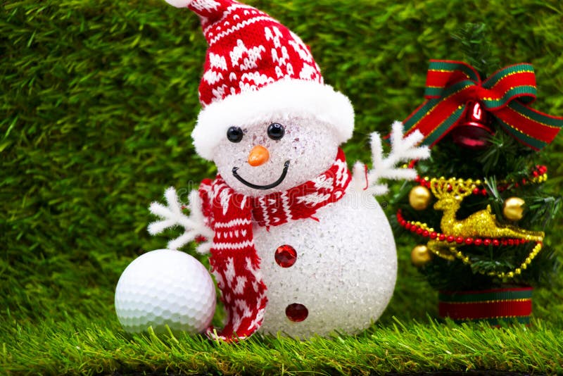 Snowman is on green grass background with one golf ball. Snowman is on green grass background with one golf ball