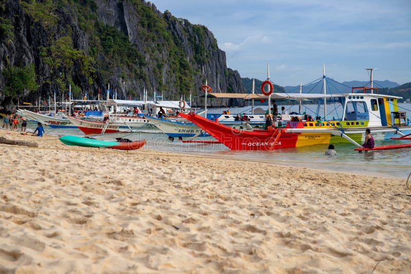 El Nido, the Philippines - 20 Nov 2018: sea landscape with colorful boats and sand beach. Palawan island Idyllic beach