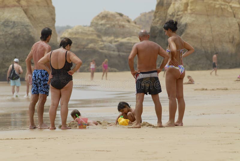 El reloj de la gente embroma jugar en la playa en Portimao, Portugal foto de archivo libre de regalías El reloj de la gente embroma jugar en la playa en Portimao, Portugal foto de archivo libre de regalías