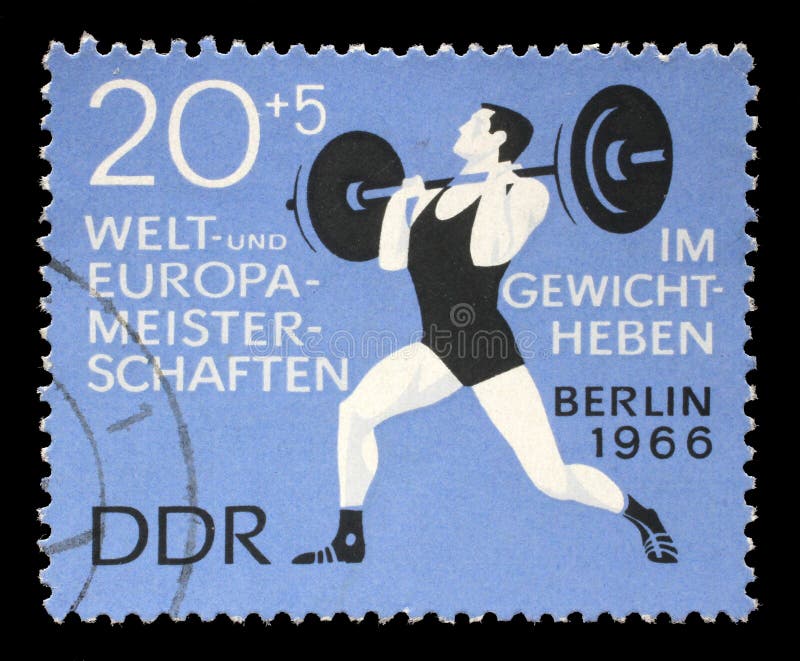 El sello impreso en RDA muestra al weightlifter fotografía de archivo