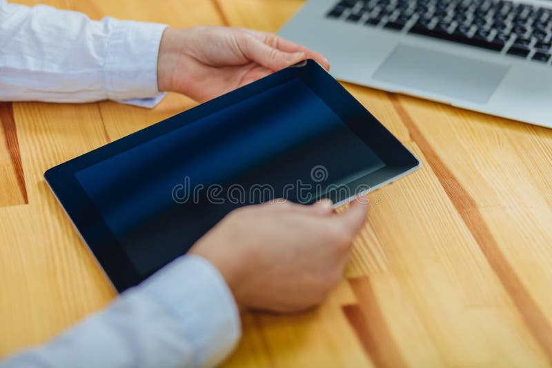 El tacto de la mano en la pantalla vacía del aboveon de la tableta una opinión de sobremesa ligera, deja el espacio para la exhib fotos de archivo libres de regalías El tacto de la mano en la pantalla vacía del aboveon de la tableta una opinión de sobremesa ligera, deja el espacio para la exhib fotos de archivo libres de regalías