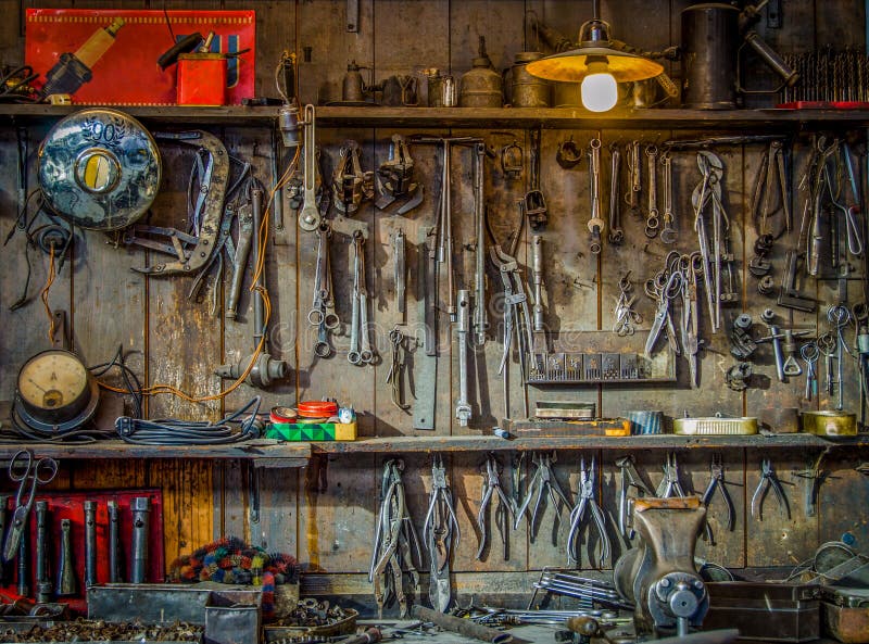 Vintage Tools Hanging On A Wall In A Tool Shed Or Workshop. Vintage Tools Hanging On A Wall In A Tool Shed Or Workshop