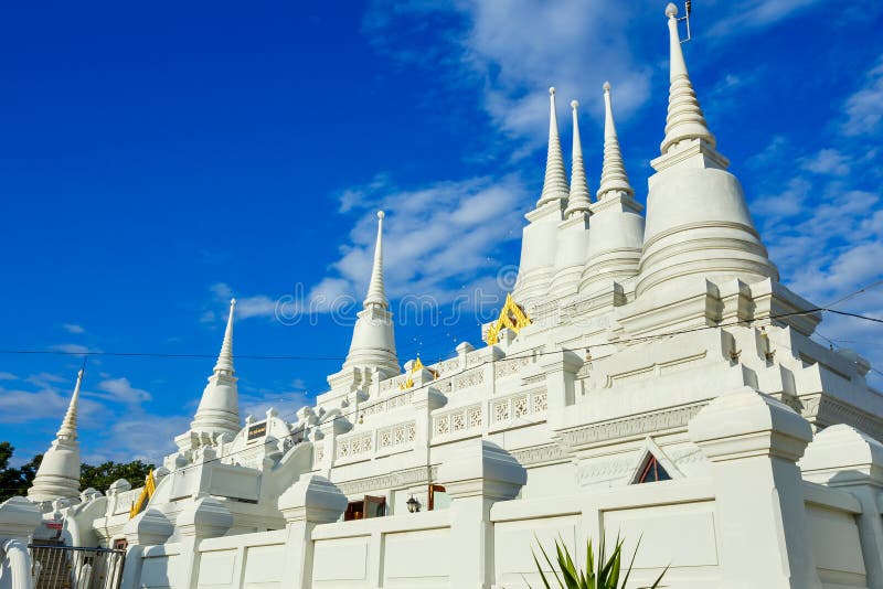 White Buddhist Pagoda with multiple spires at Wat Asokaram Temple in Thailand