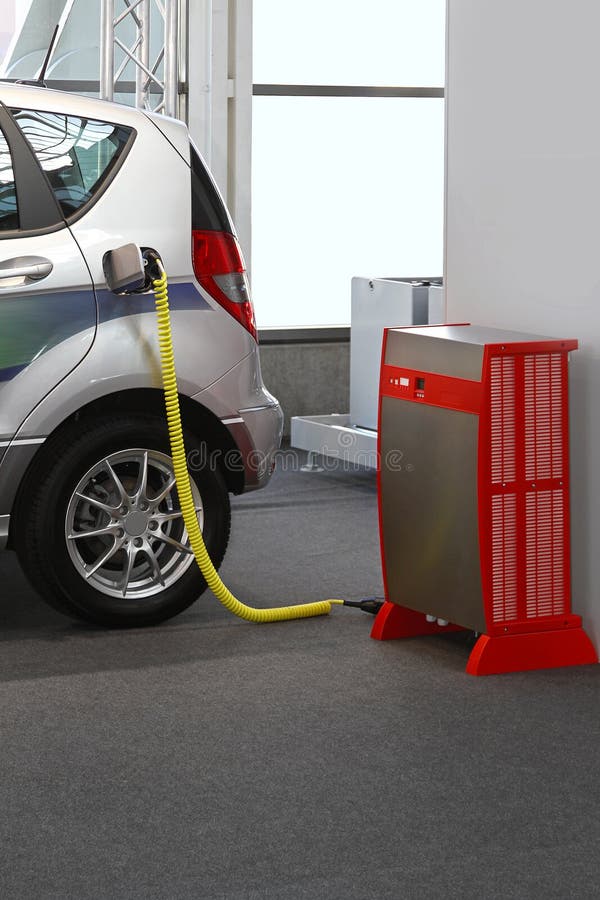 Electric vehicle with plugged cable in charging station. Electric vehicle with plugged cable in charging station